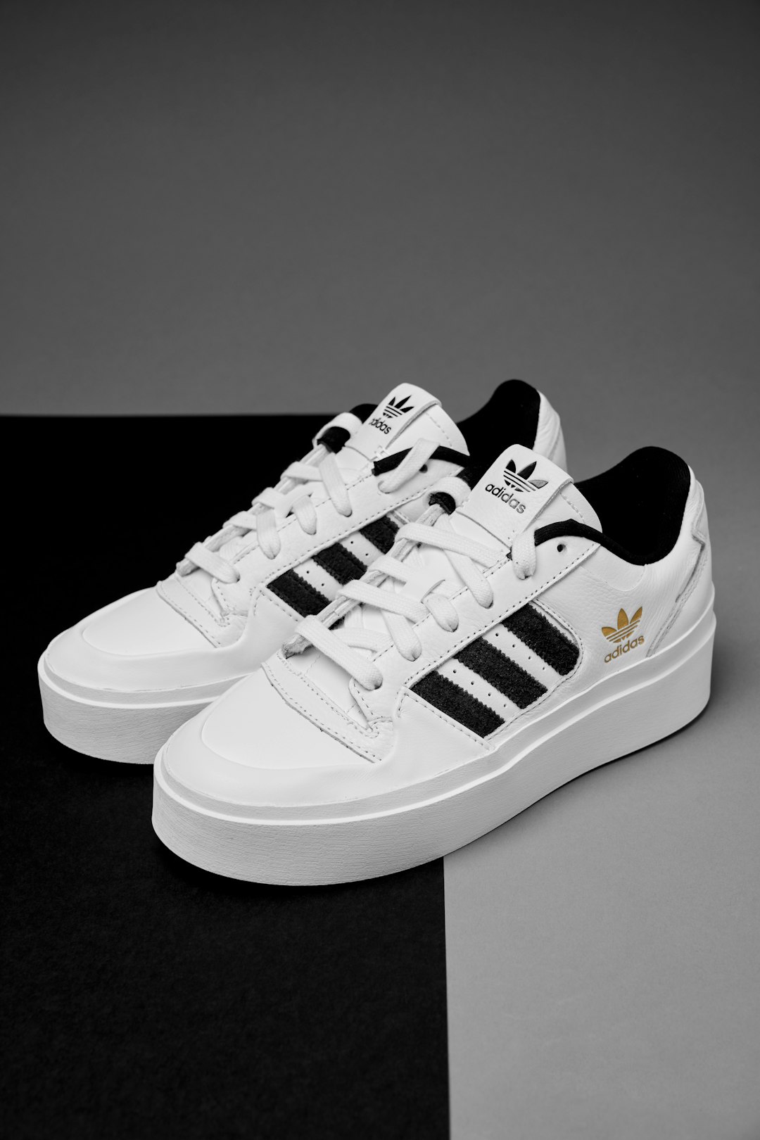 a-pair-of-white-and-black-adidas-sneakers-jlt58ekwq6k