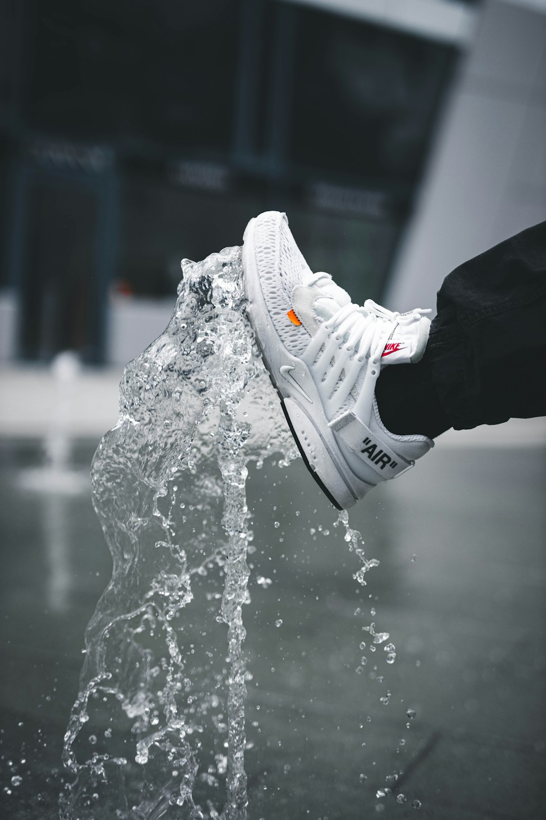 White running sneaker splashing through water as a style reference for wholesale buyers