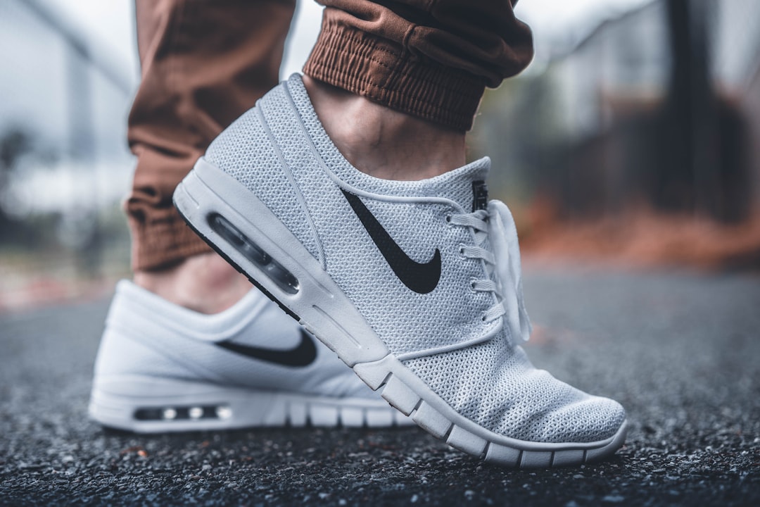 Person wearing white running sneakers featured by Sneaker Loco for wholesale buyers