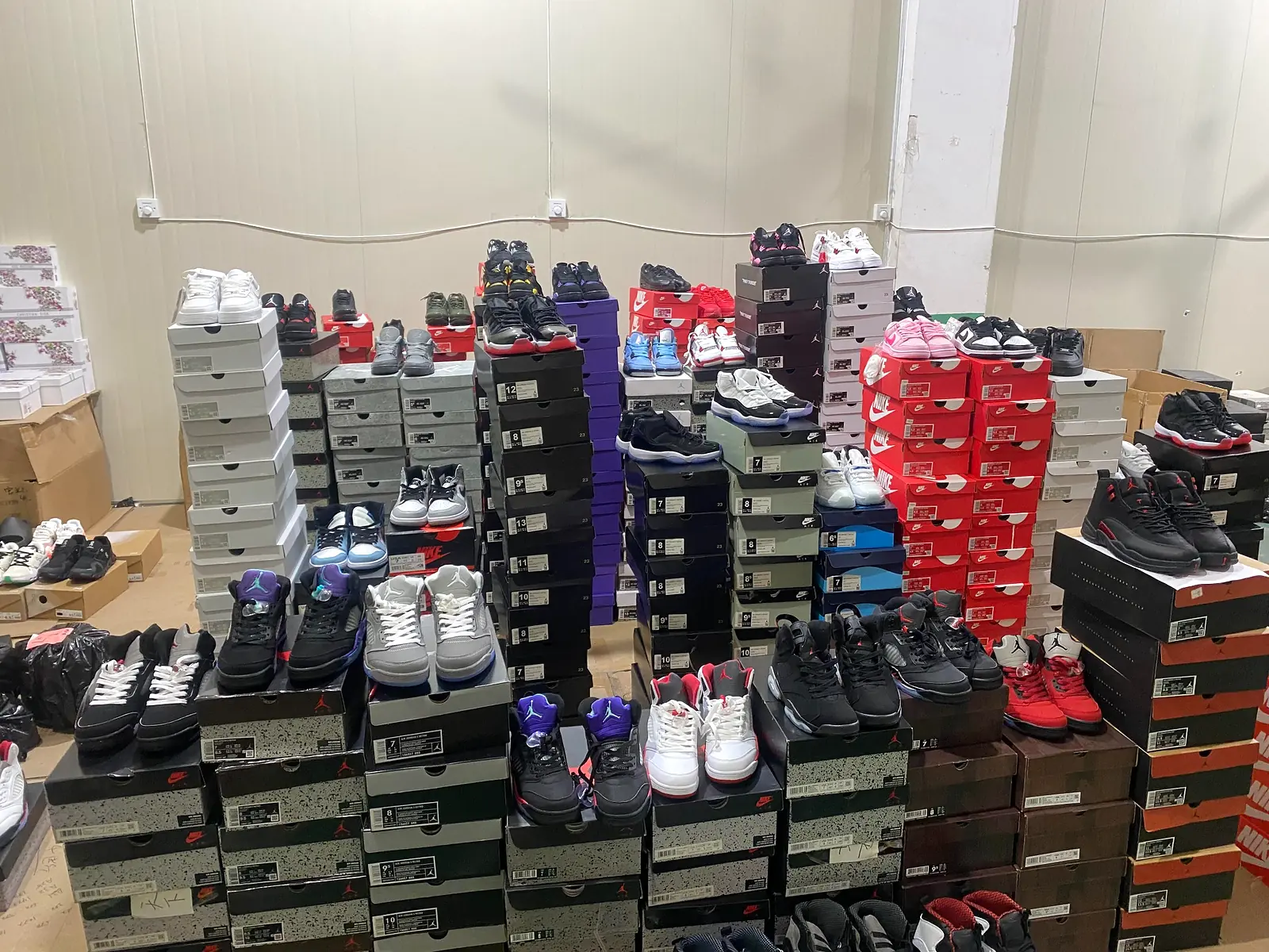 Assorted wholesale sneakers and shoe boxes prepared at SneakerLoco's China warehouse